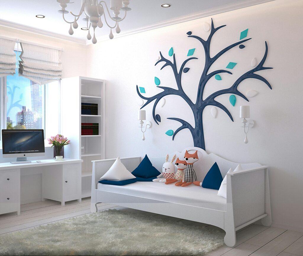 A stylish children's room with a modern design featuring a tree wall art and plush toys.